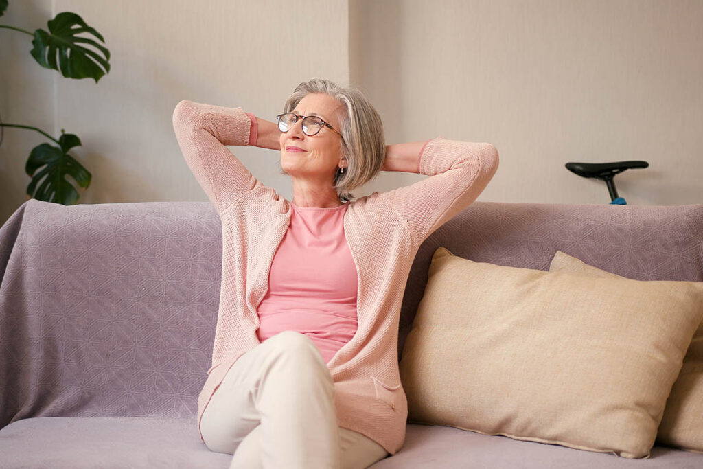 person sitting comfortably on couch contemplating treatment goals for anxiety