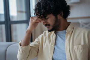 person hanging head while experiencing marijuana withdrawal symptoms