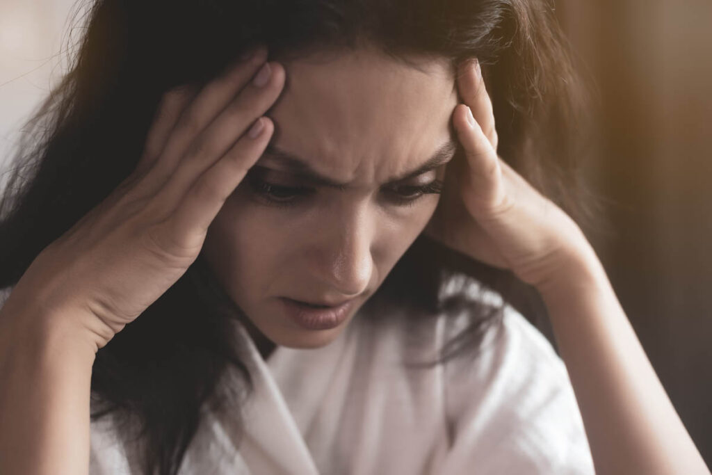 person holding temples while thinking anxiety is ruining my life