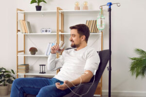 person in office enjoying a glass of water while contemplating the future of nad therapy