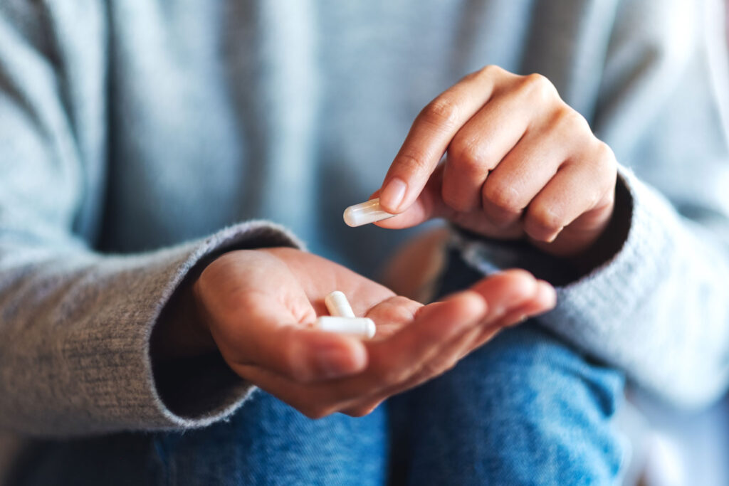 person sorting through supplements to take with NAD